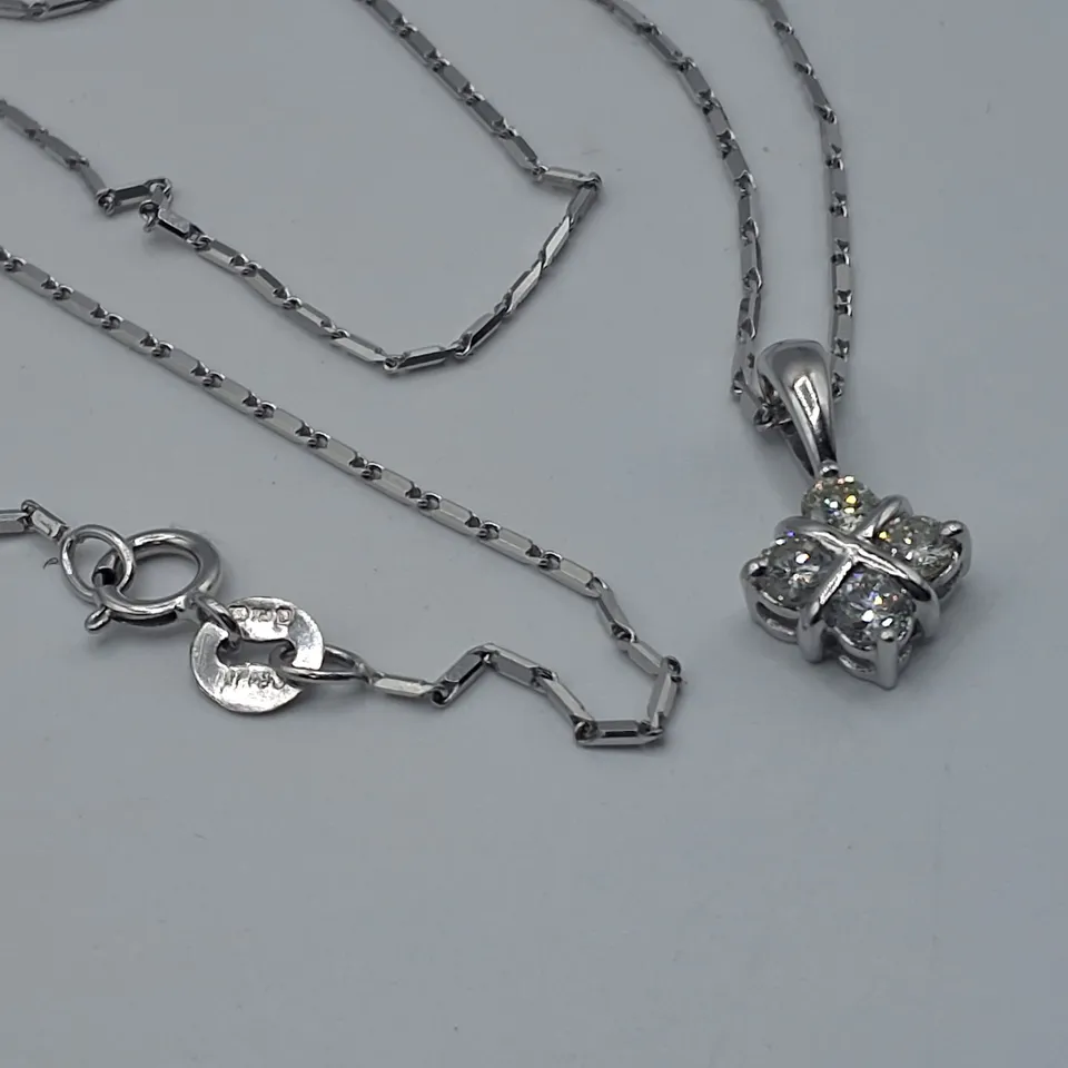 18CT WHITE GOLD SALTIRE PENDANT ON CHAIN SET WITH NATURALS