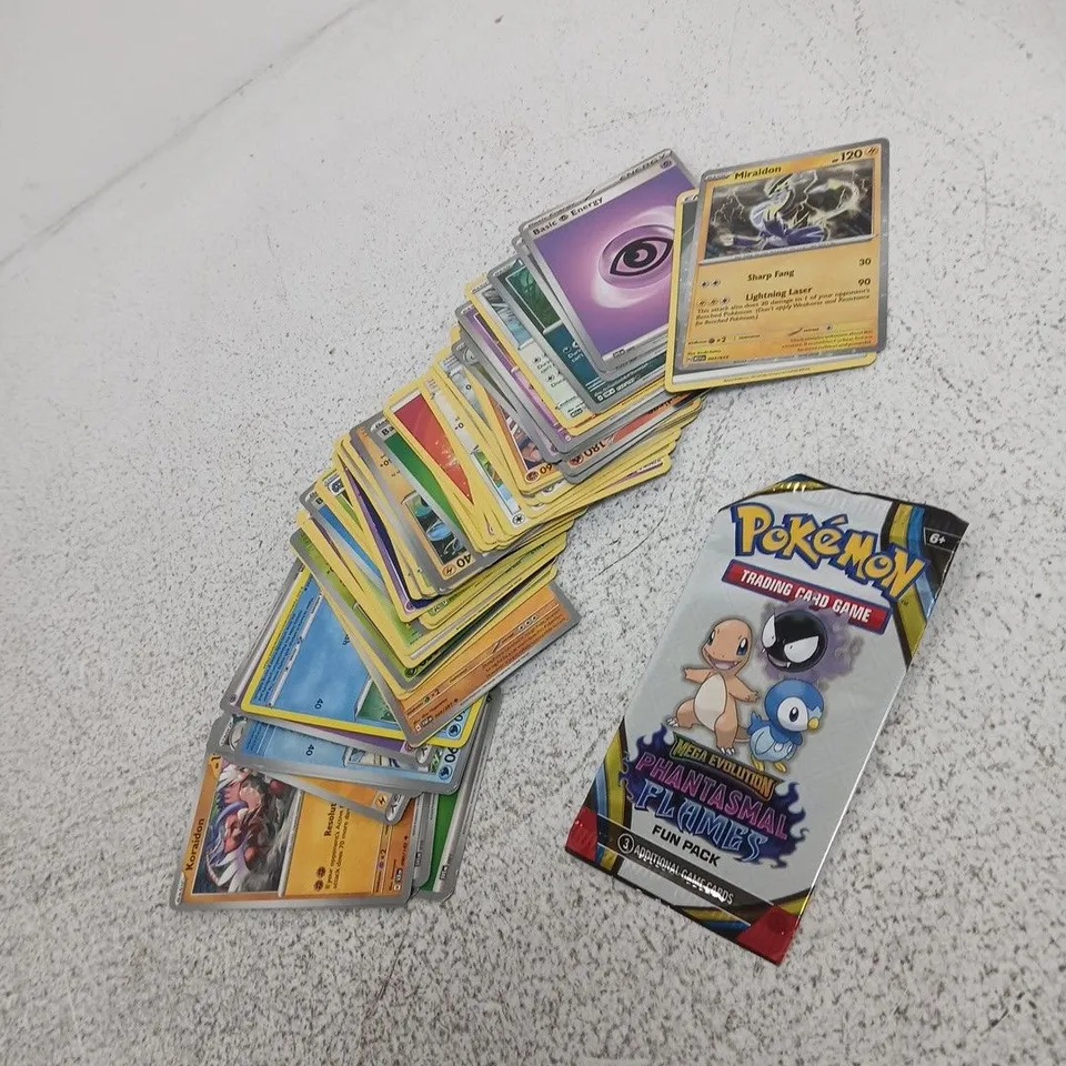 POKÉMON TRADING CARD TIN WITH ASSORTED CARDS AND PHANTOM FLAMES BOOSTER PACK