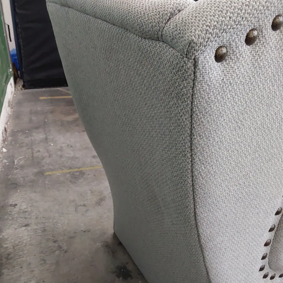 DESIGNER HIGH BACKED WINGED EASY CHAIR WITH STUDDED DETAIL 
