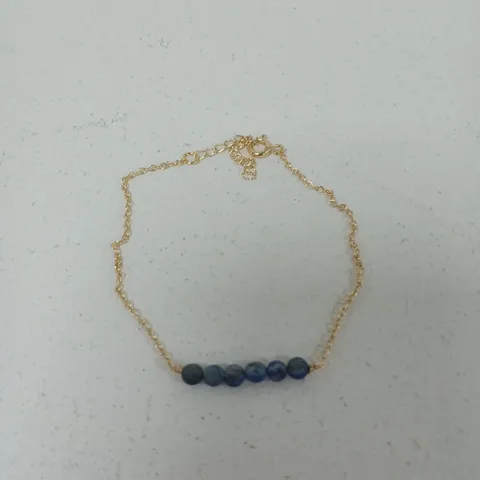 GOLD-TONE BRACELET WITH BLUE BEAD ACCENT