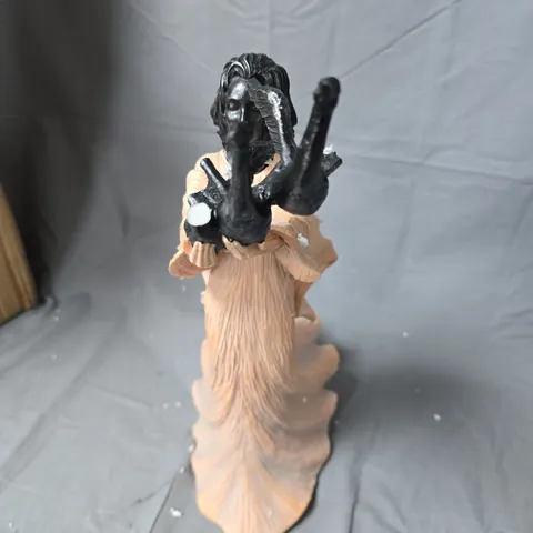 SCULPTURE OF A WOMAN IN PEACH GOWN WITH BLACK BIRD FORMS ON TOP-BROKEN WING 