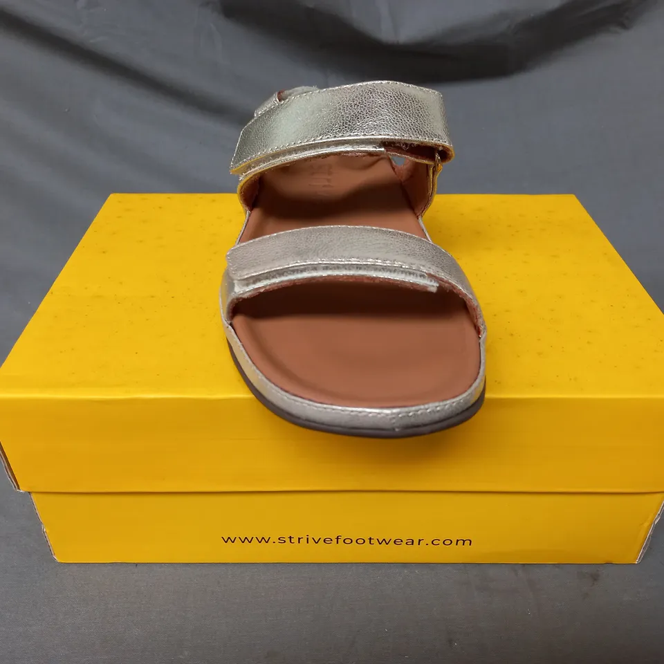 BOXED PAIR OF STRIVE SANDALS IN METALLIC GOLD SIZE 5