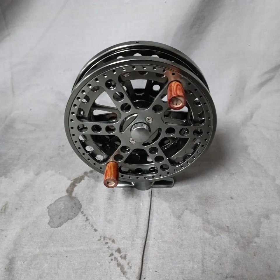FLY FISHING REEL WITH PERFORATED SPOOL AND WOODEN KNOB HANDLES IN BLACK POUCH