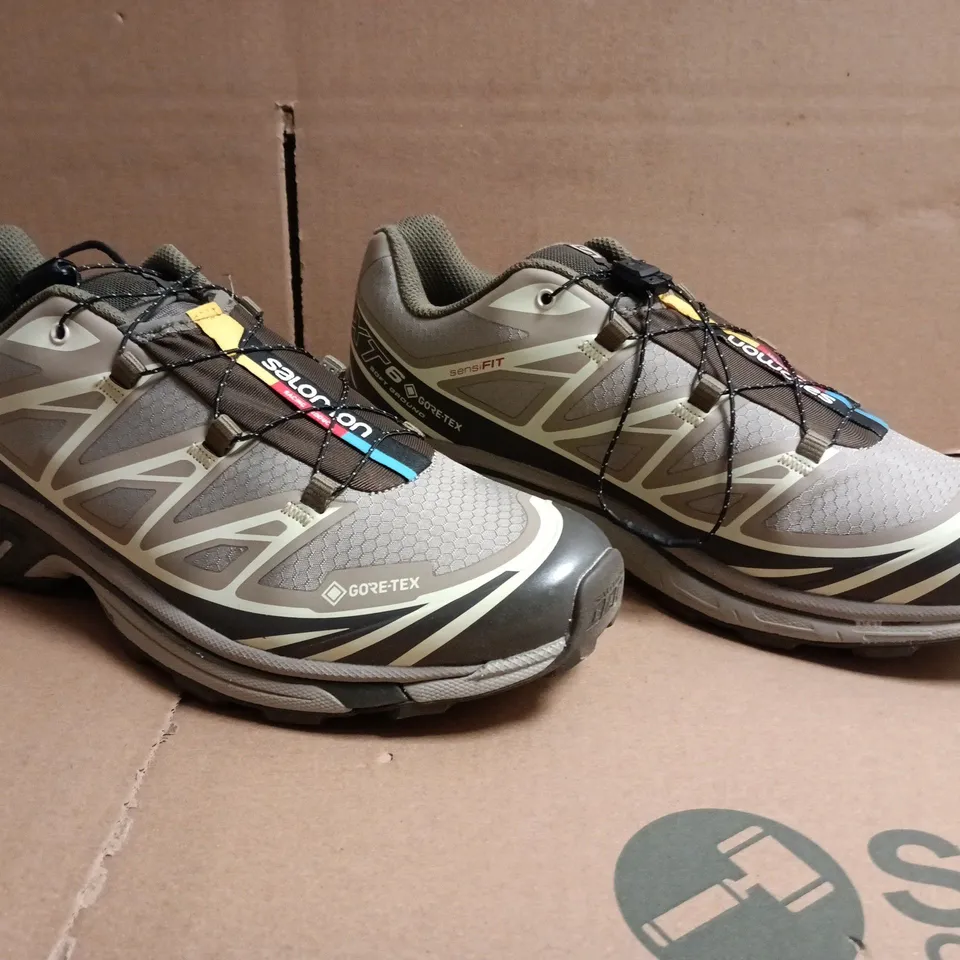 BOXED PAIR OF SALOMON TRAINERS IN LIGHT TAUPE SIZE UK 9.5