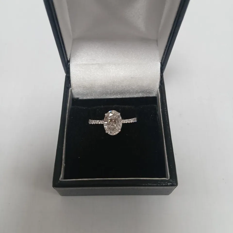 9CT WHITE GOLD RING SET WITH A LAB GROWN OVAL CUT DIAMOND TO CENTRE AND ACCENTS, WEIGHING +2.42CT
