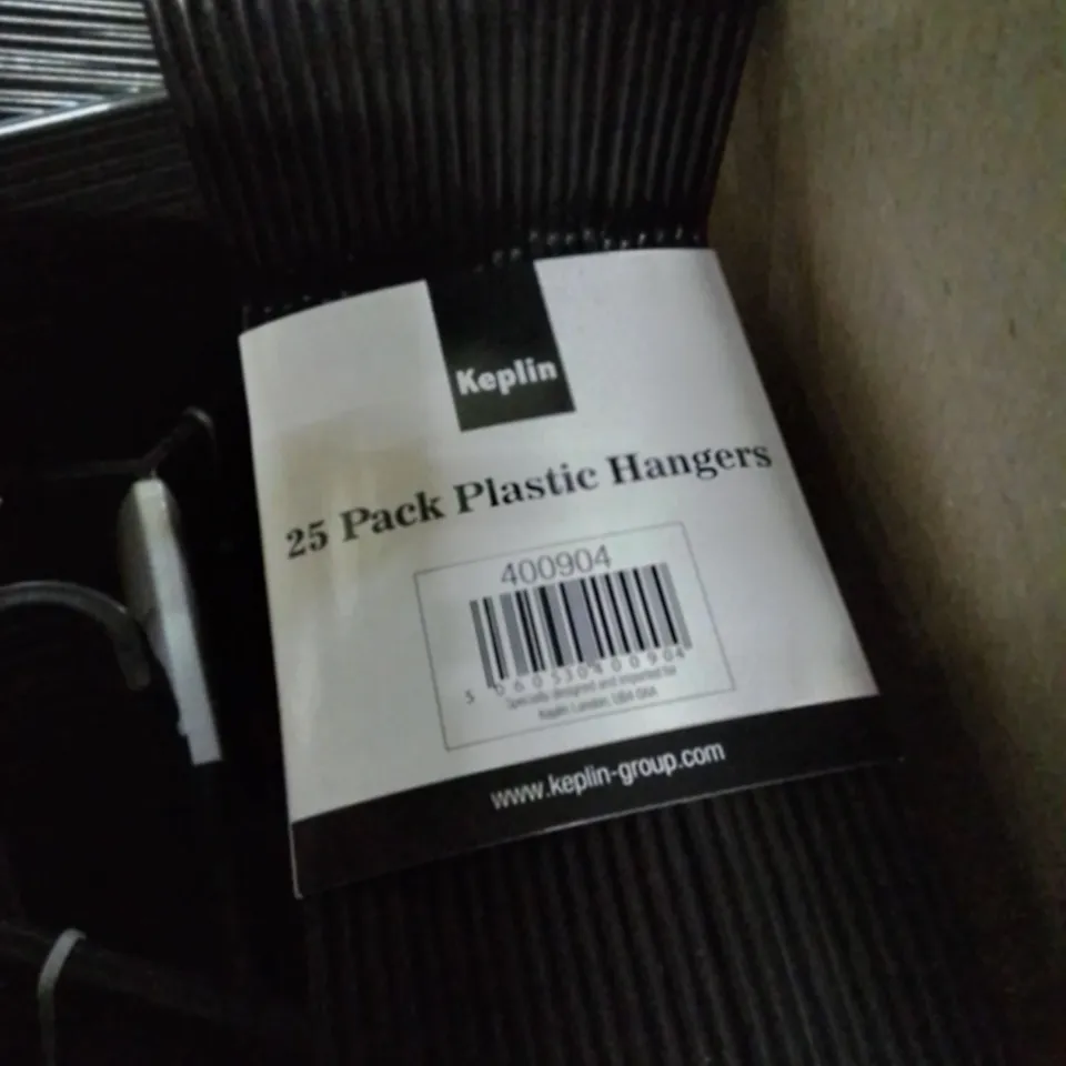 BOX CONTAINING PACKS OF 25 PLASTIC HANGERS.