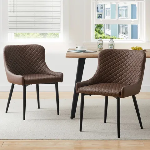 A BOXED PAIR OF BROWN FAUX LEATHER UPHOLSTERED SIDE/DINING CHAIRS