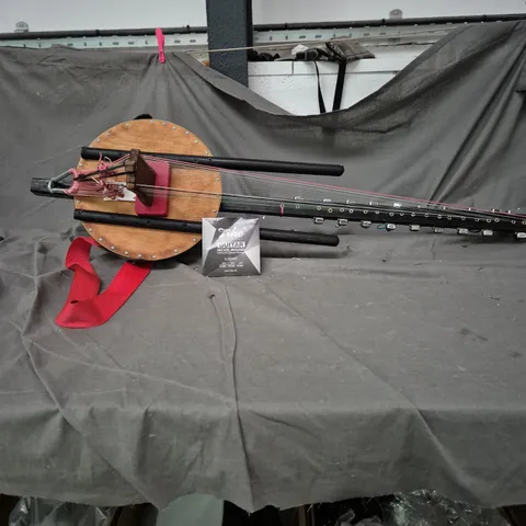 SITAR STYLE STRINGED INSTRUMENT WITH CIRCULAR WOODEN BODY AND LONG NECK