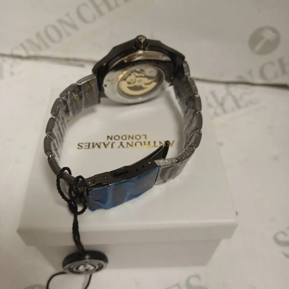 BOXED ANTHONY JAMES GENTS SPORTS SKELETON WATCH WITH STAINLESS STEEL BRACELET. 