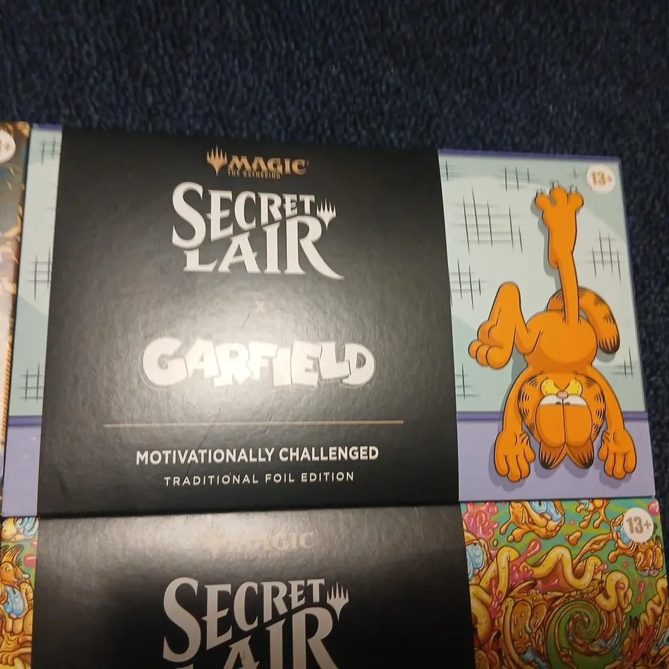 SIX ASSORTED MAGIC: THE GATHERING SECRET LAIR BOOSTERS TO INCLUDE; GARFIELD & FELIX THE CAT EACH PACK CONTAINS 5 CARDS