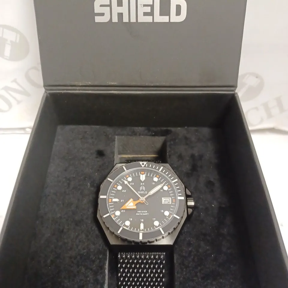 BOXED SHIELD WATCH - STAINLESS STEEL - JAPAN MOVEMENT - WATER RESISTANT 20 ATM - DATE DIAL.