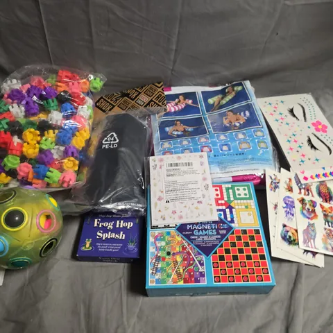 TOTE OF APPROX 5 ASSORTED TOYS AND GAMES TO INCLUDE STICKERS, SHIN PADS AND MAGNETIC GAMES 