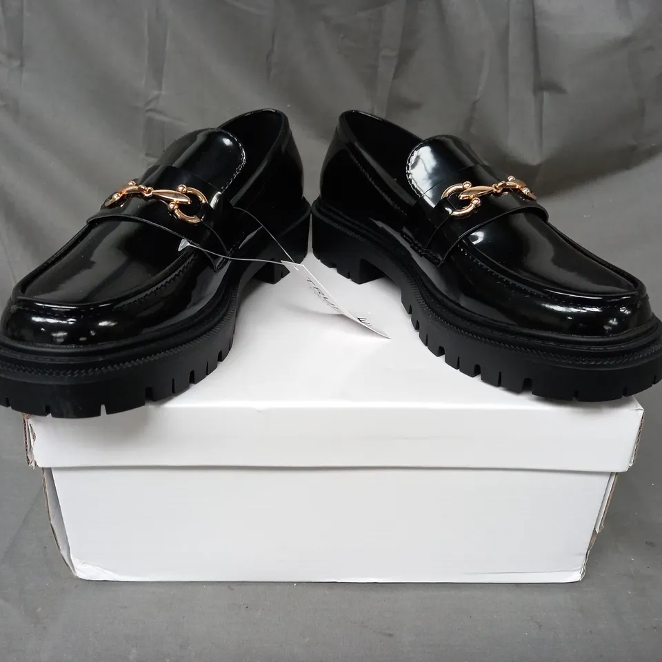 BOXED PAIR OF TRUFFLE COLLECTION LOAFERS IN GLOSSY BLACK W. GOLD EFFECT DETAIL SIZE 5