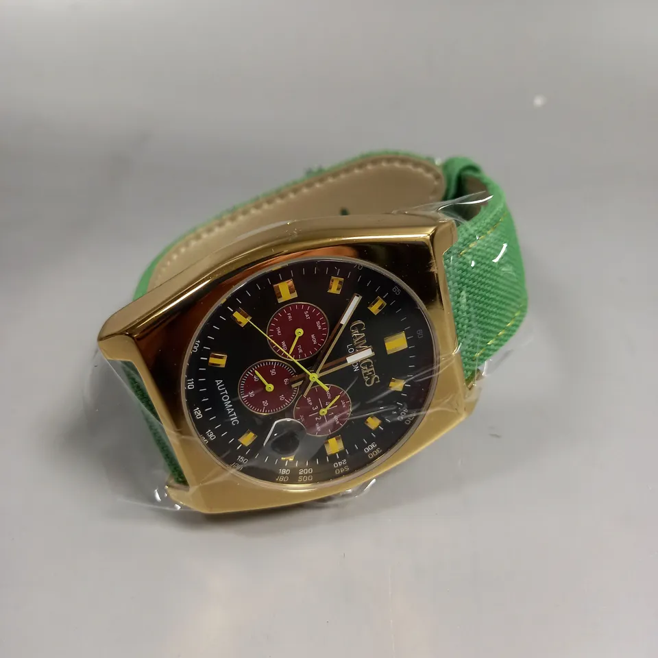 BOXED GAMAGES RETRO CALIBRE GOLD/GREEN WATCH