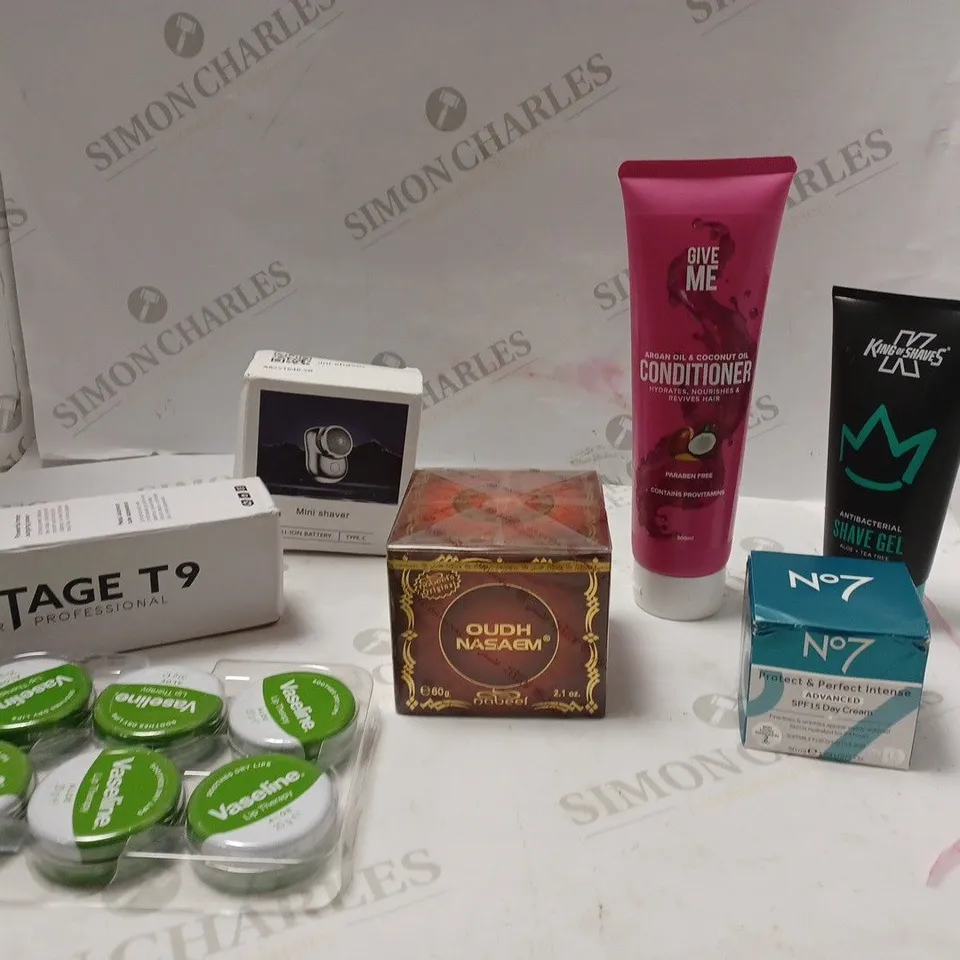 Box of assorted beauty products including trimmer and shaver