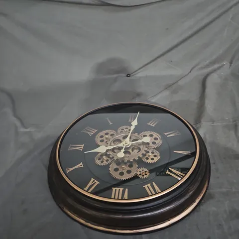 ROUND WALL CLOCK WITH EXPOSED BRASS GEARS, ROMAN NUMERALS, BLACK FINISH