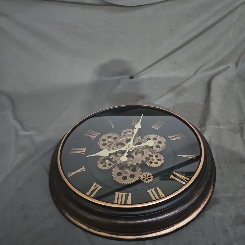 ROUND WALL CLOCK WITH EXPOSED BRASS GEARS, ROMAN NUMERALS, BLACK FINISH