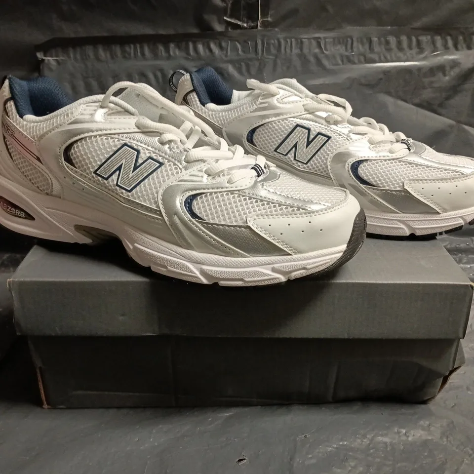 BOXED PAIR OF NEW BALANCE 530 TRAINERS IN WHITE/SILVER/NAVY SIZE UK 10