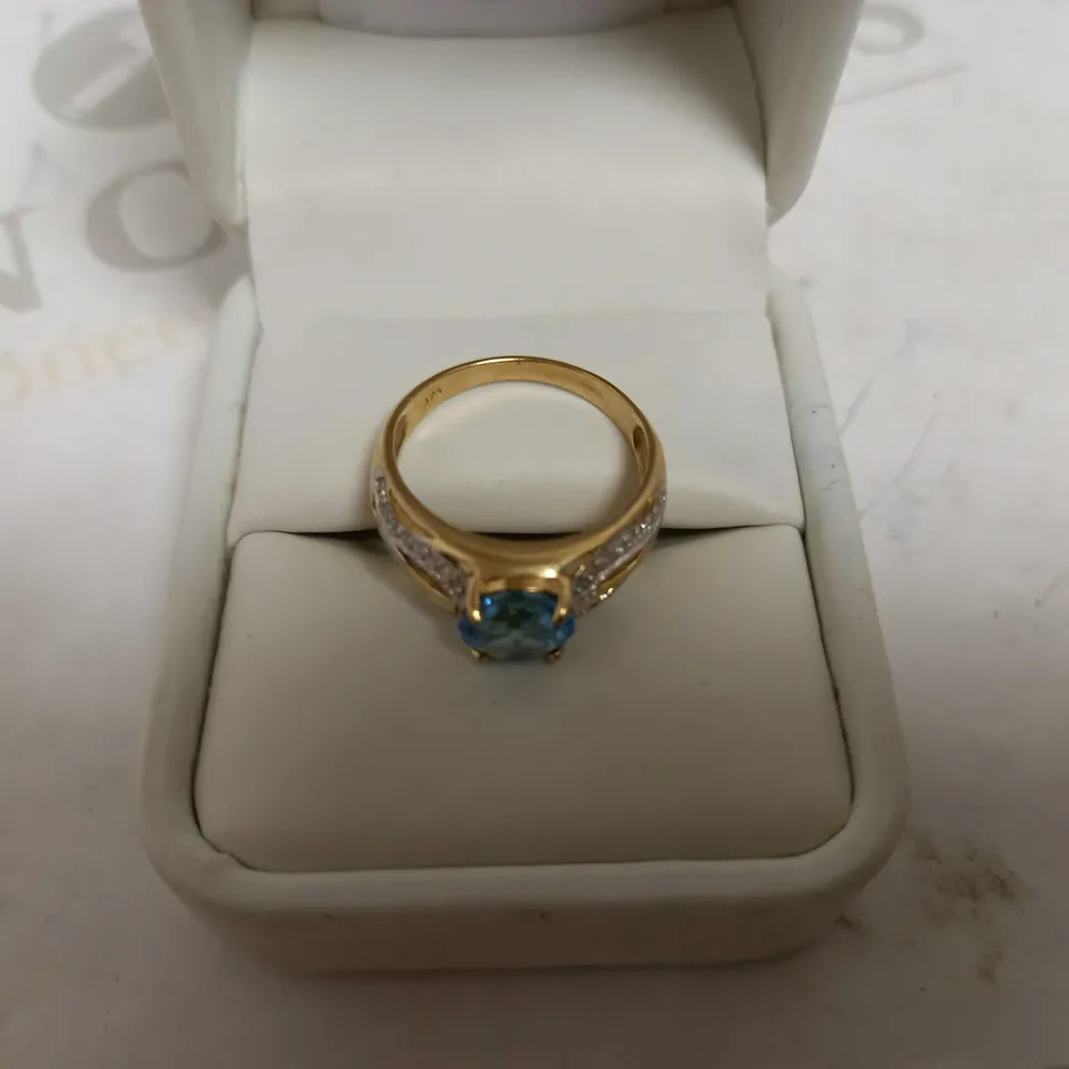 DESIGNER 9CT YELLOW GOLD RING SET WITH A BLUE TOPAZ AND DIAMONDS WEIGHING +-2.10CT