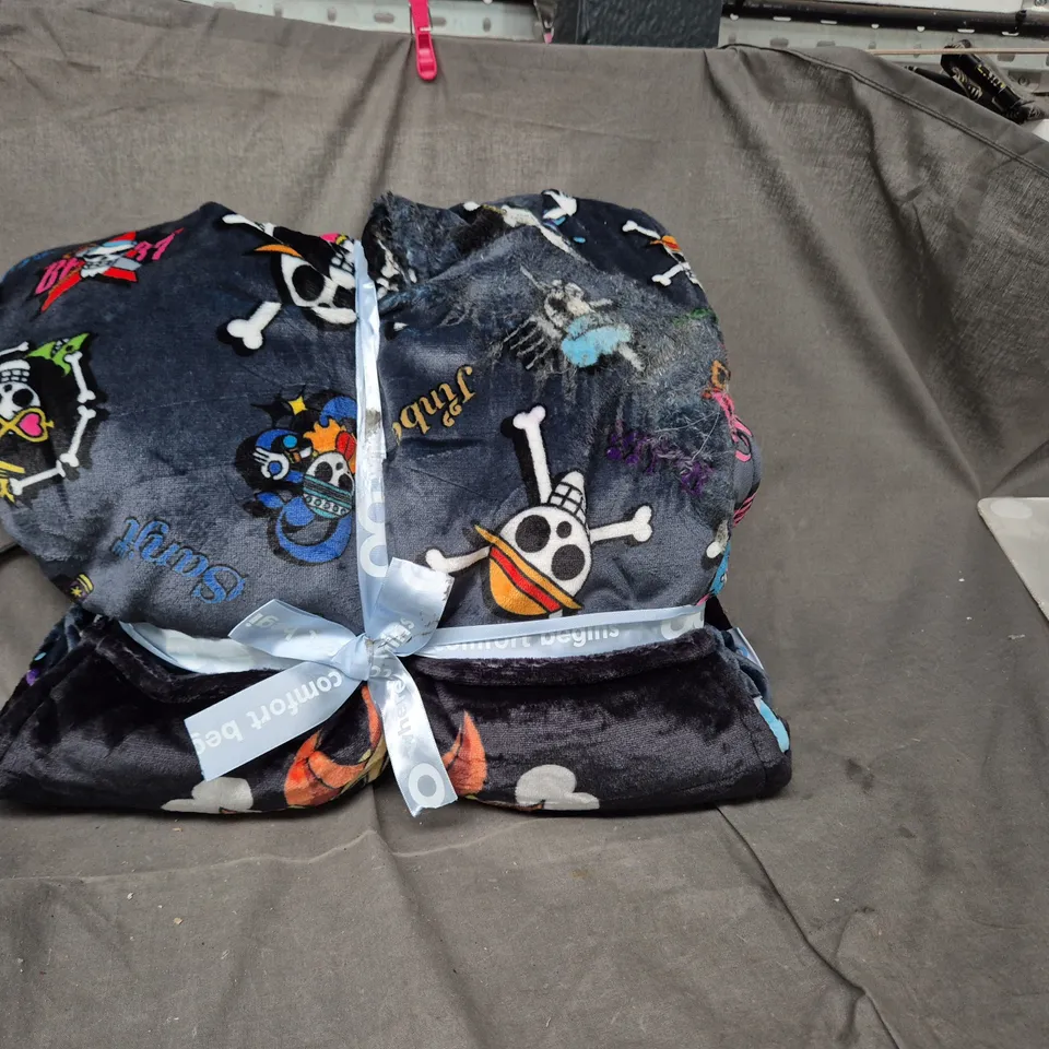 WHERE COMFORT BEGINS – NAVY BLUE SKULL & CROSSBONES MOTIF, TIED WITH PALE BLUE RIBBON