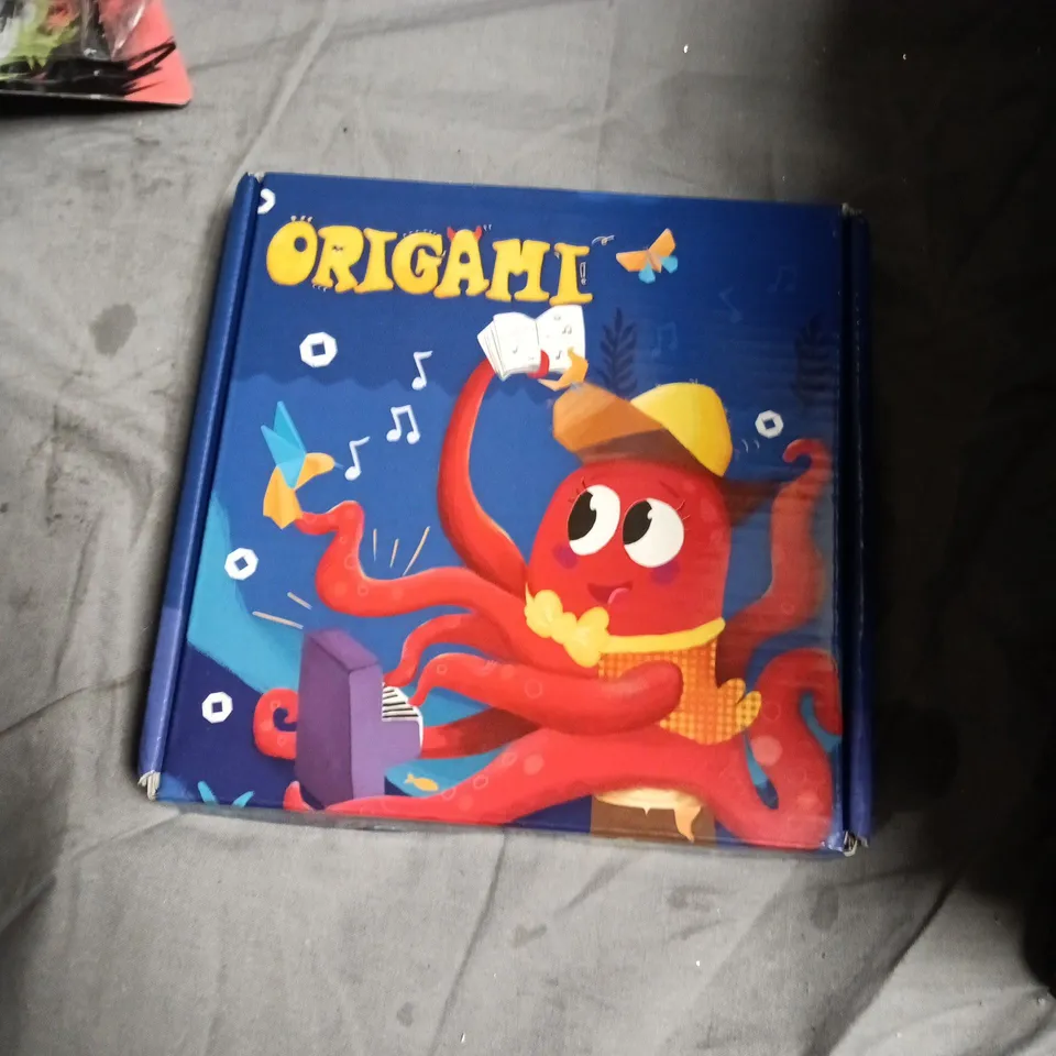 BOX OF APPROXIMATELY 10 ASSORTED TOYS INCLUDING ORIGAMI , DRGONBALL FIGURE AND MAN UNITED RUBIKS CUBE 