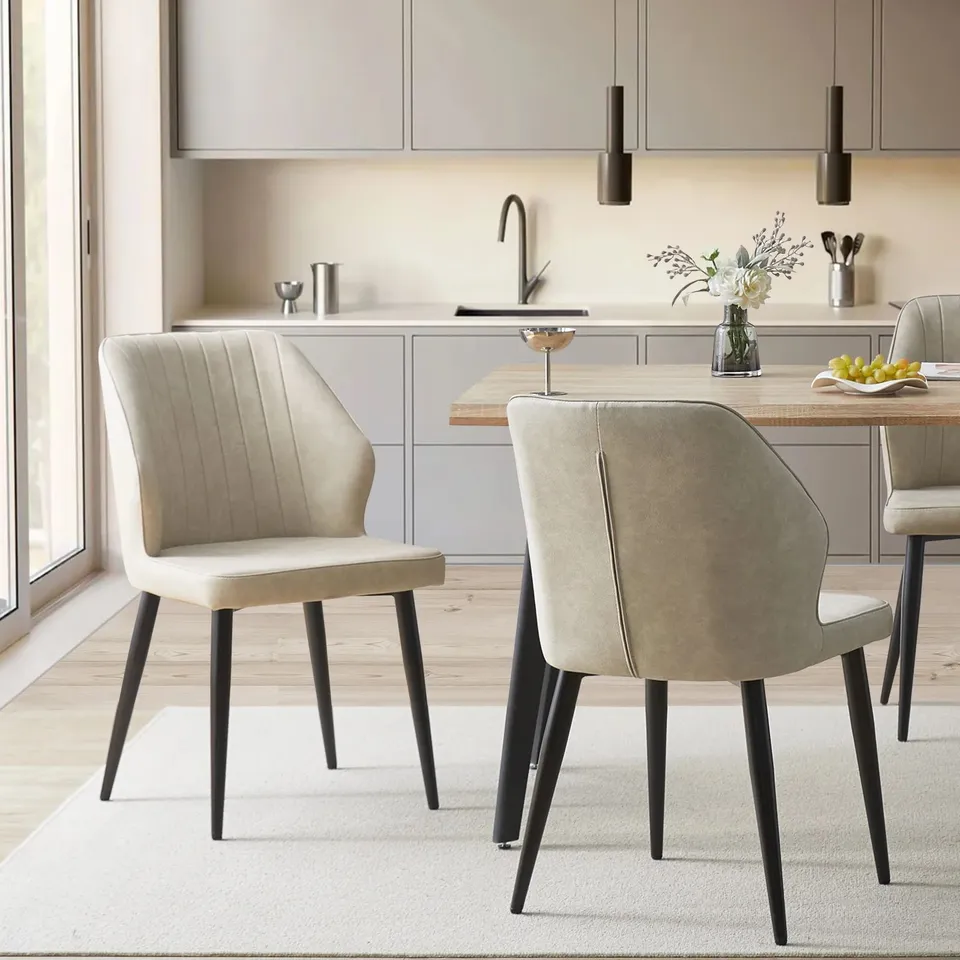 BOXED PAIR OF CREAM FAUX LEATHER UPHOLSTERED SIDE CHAIRS 