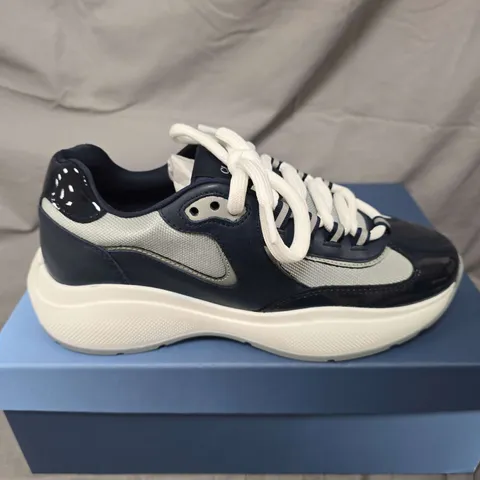 BOXED PAIR OF CLEENS PODIUM TRAINERS IN INDIGO - UK 7.5