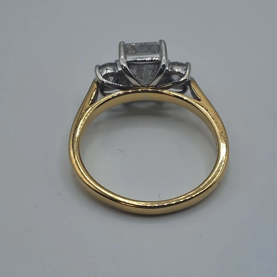18CT RING SET WITH A NATURAL RADIANT CUT DIAMOND AND A NATURAL DIAMOND TO EACH SHOULDER WEIGHING +-2.46CT