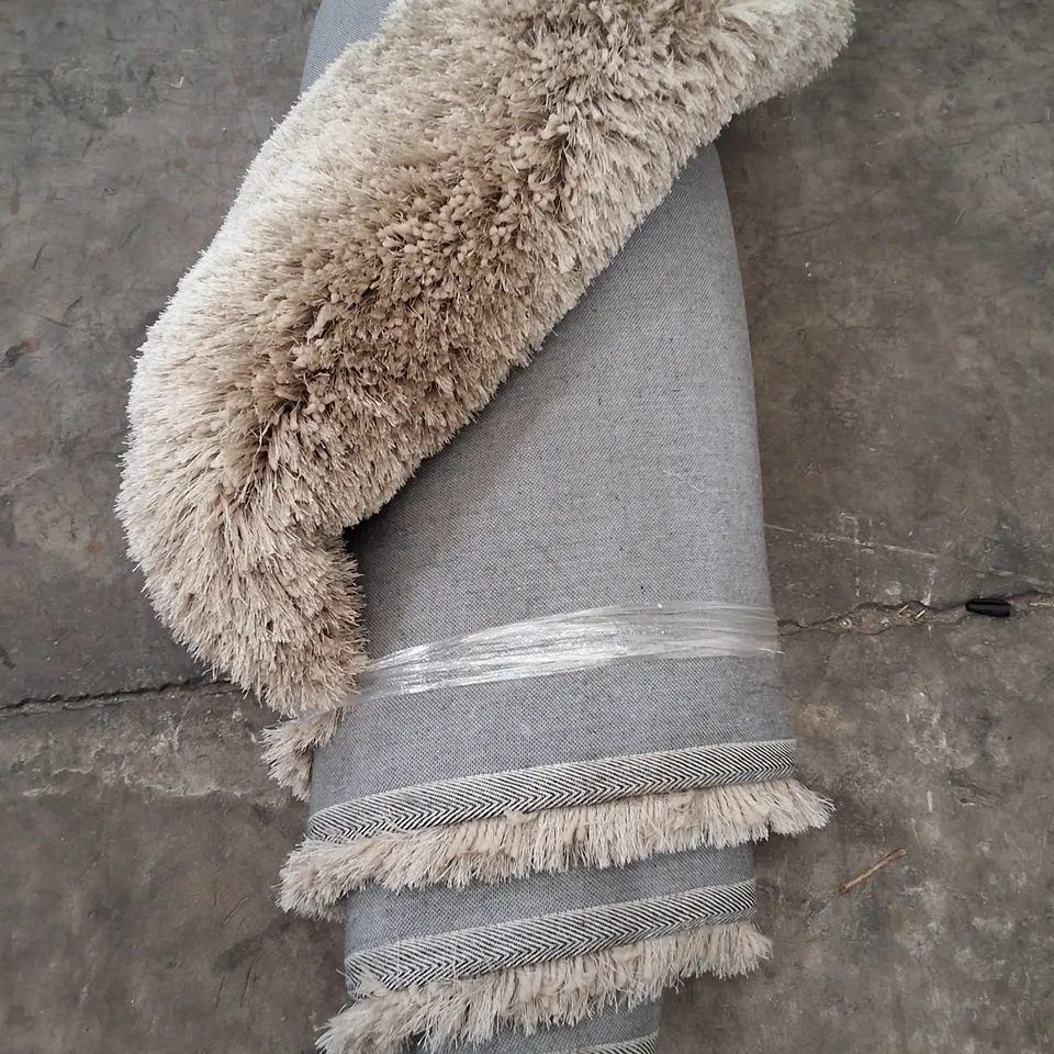 LARGE ROLLED SHAGGY RUG IN NATURAL