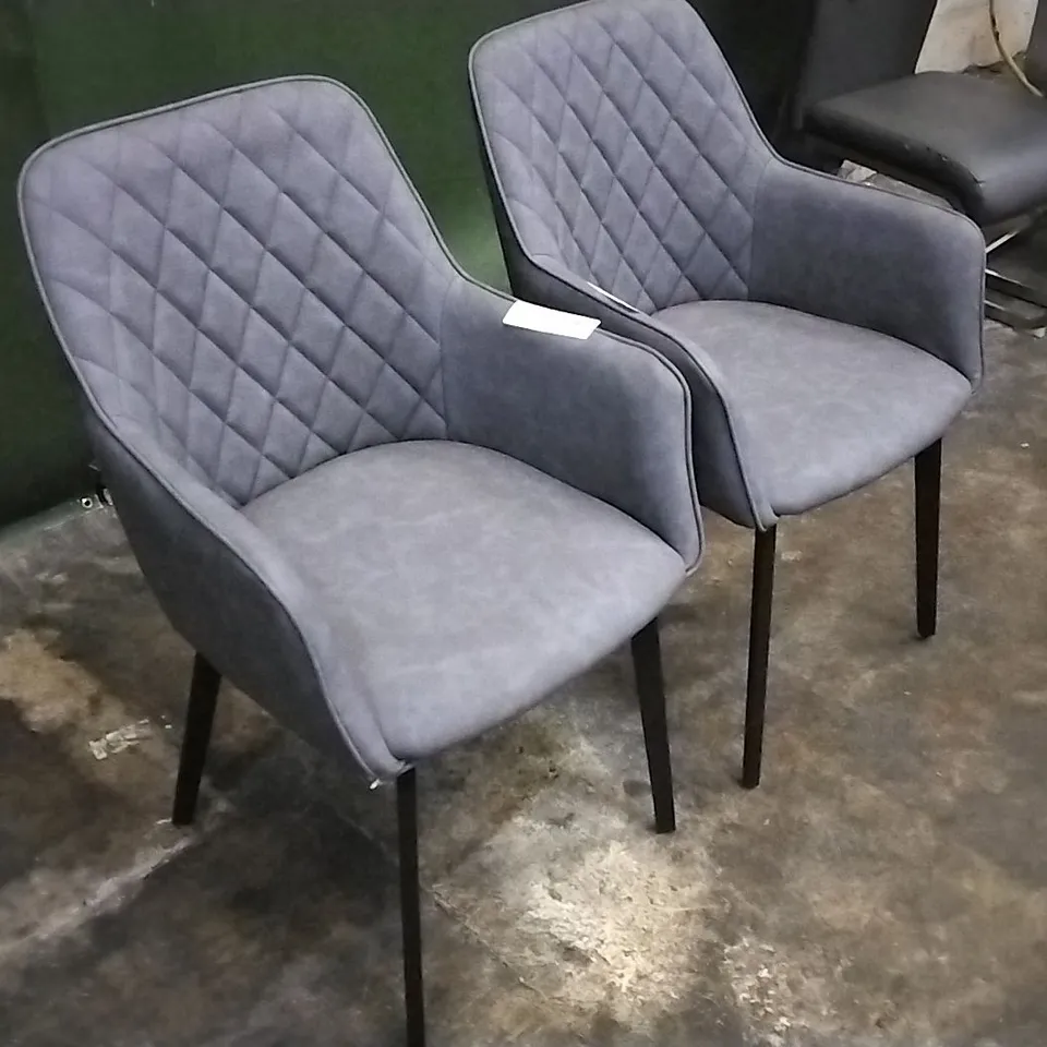 DESIGNER PAIR OF GREY LEATHER PILLOWED DINING CHAIRS WITH ARMREST AND BLACK LEGS