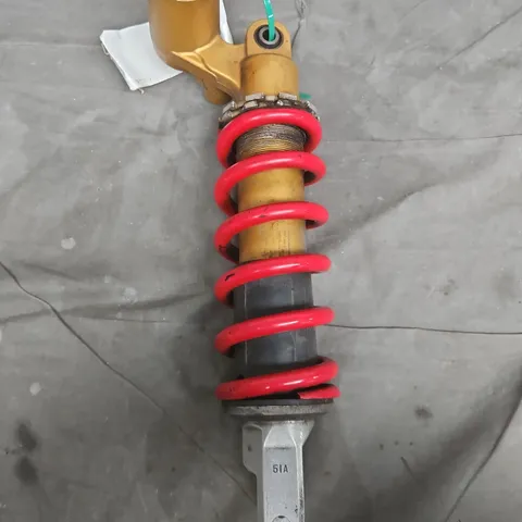 Coilover suspension strut with red coil spring – vehicle part
