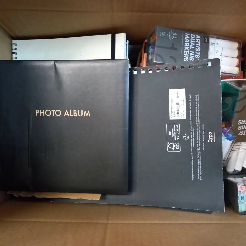 MEDIUM BOX OF ASSORTED NOTE BOOKS , SHARPIES AND PHOTO ALBUM