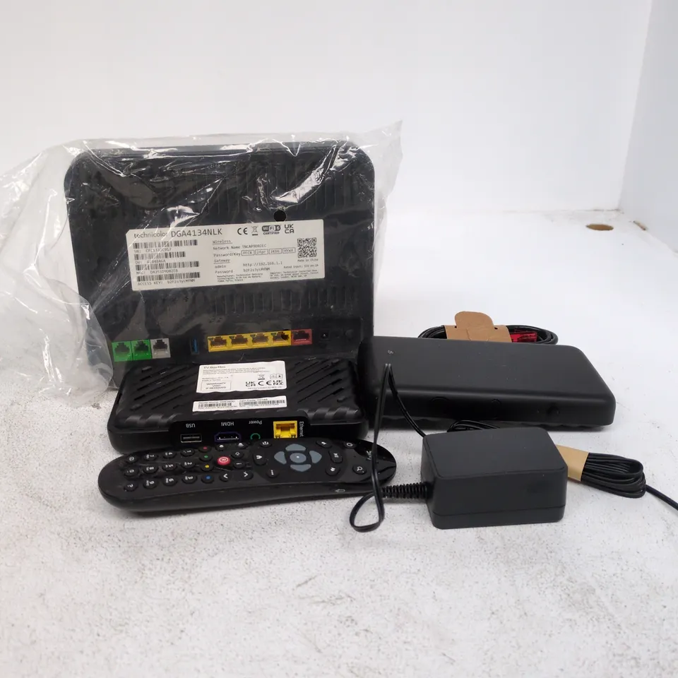 TOTE OF APPROXIMATELY 15 ASSORTED ITEMS TO INCLUDE TV BOX MINI, ROUTER, POWER SUPPLY, CABLES, REMOTE CONTROLS ETC