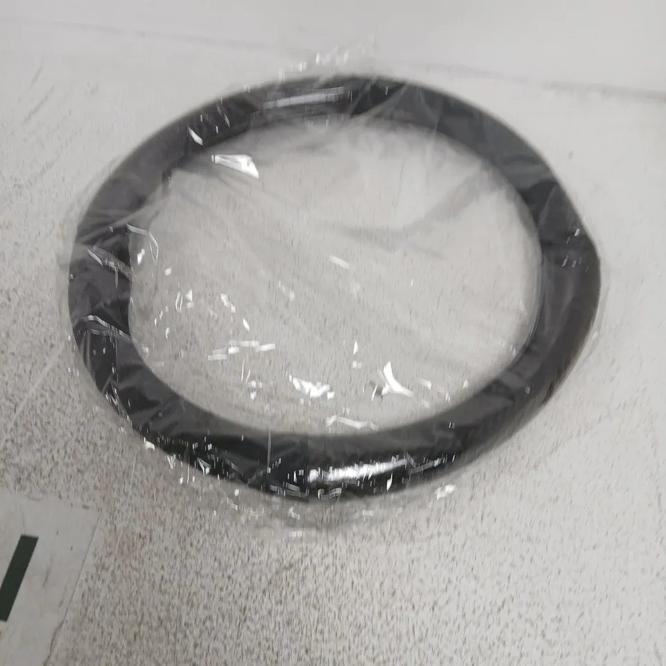 Black circular steering wheel cover – new in packaging