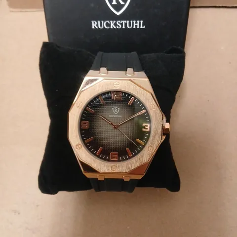 RUCKSTUHL WRISTWATCH – ROSE GOLD TONE CASE, BLACK DIAL, RUBBER STRAP