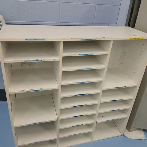 WHITE FREESTANDING SHELVING UNIT WITH THREE VERTICAL SECTIONS AND MULTIPLE ADJUSTABLE SHELVES