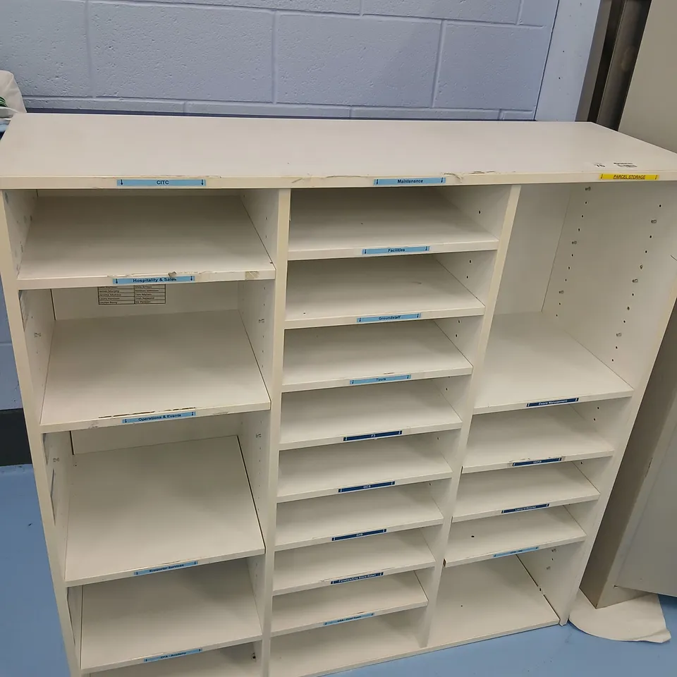 WHITE FREESTANDING SHELVING UNIT WITH THREE VERTICAL SECTIONS AND MULTIPLE ADJUSTABLE SHELVES