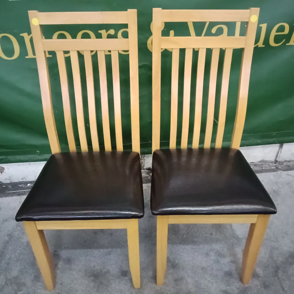 PAIR OF WOODEN DINING CHAIRS WITH BLACK FAUX LEATHER SEAT PADS 