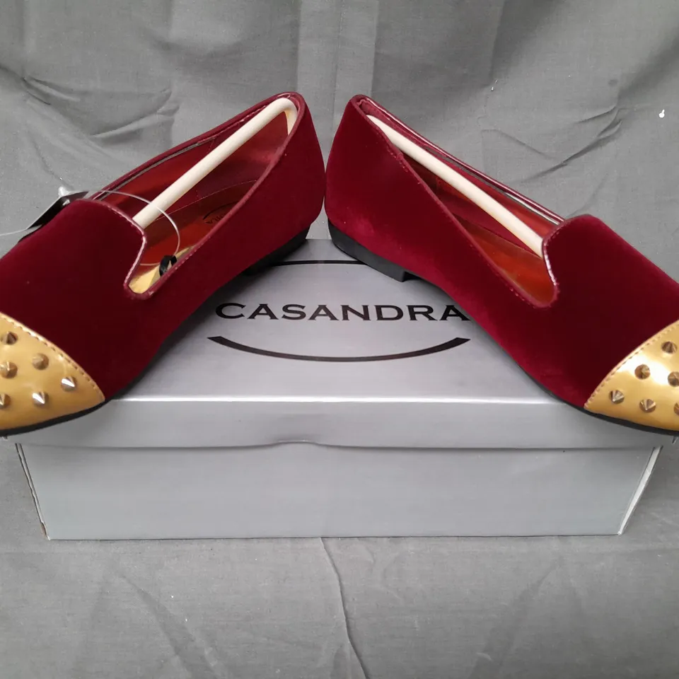 BOX OF APPROXIMATELY 12 BOXED PAIRS OF CASANDRA SLIP-ON SHOES IN RED/GOLD W. SPIKE STUDS - VARIOUS SIZES