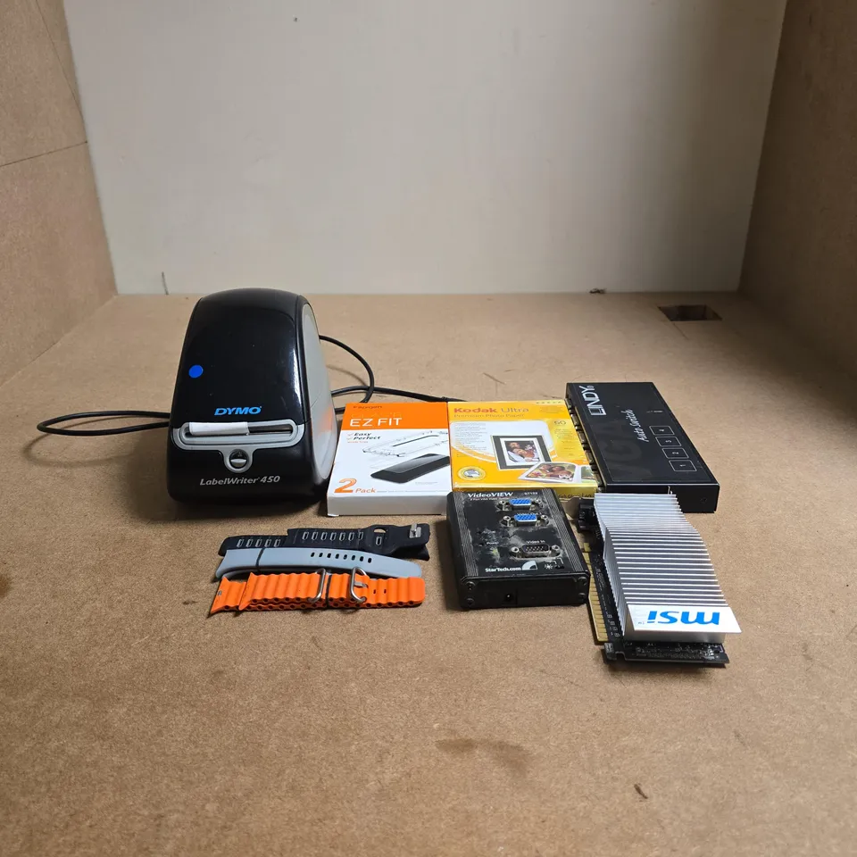 BOX OF APPROXIMATELY 50 ASSORTED ITEMS TO INCLUDE DYMO LABEL WRITER, EZ FIT SCREEN PROTECTOR, KODAK ULTRA PREMIUM PHOTO PAPER, LINDY 4 PORT VIDEO/AUDIO SWITCH, VARIETY OF WATCH STRAPS ETC