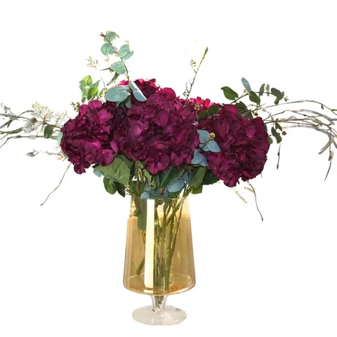 PEONY HYDRANGEAS & FOLIAGE IN AN AMBER FOOTED VASE