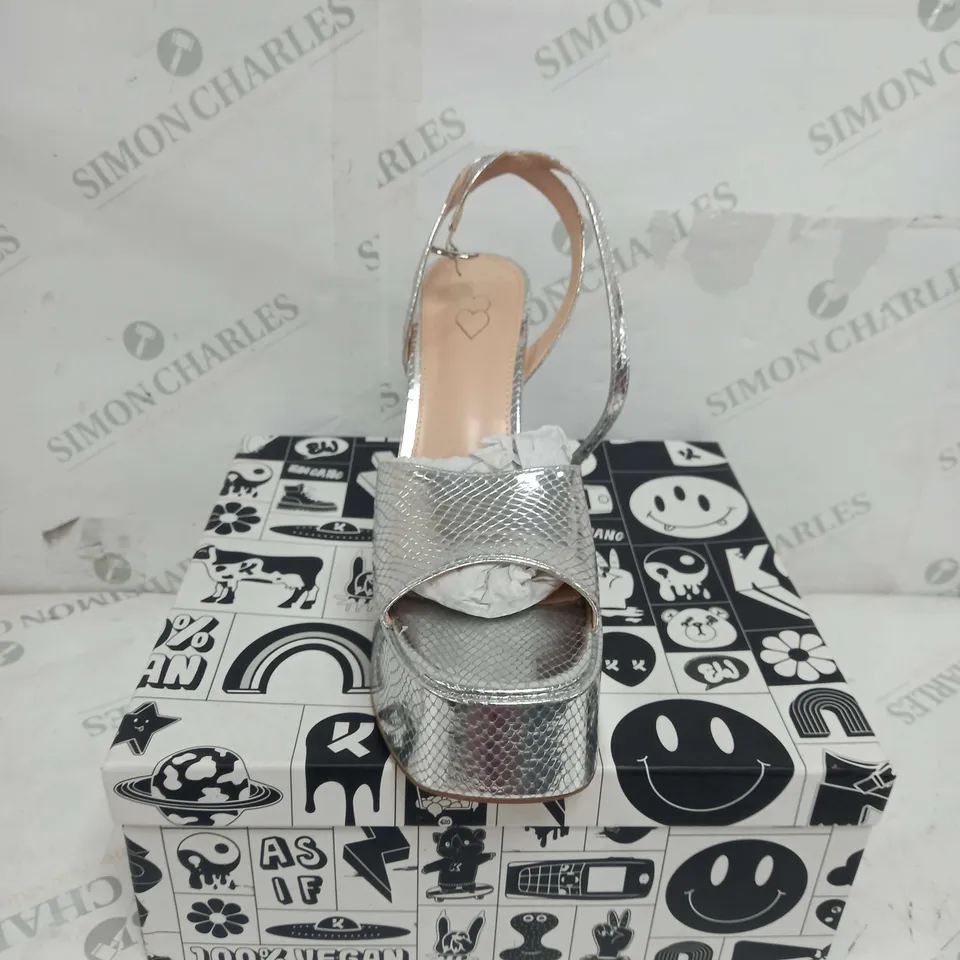 BOXED PAIR OF KOI FOOTWEAR STRAPPY PLATFORM HEELS IN SILVER - SIZE 8