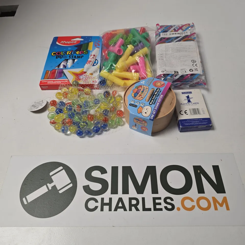 APPROXIMATELY 12 ASSORTED TOYS & GAMES PRODUCTS TO INCLUDE PLAYING CARDS, MARBLES, SQUISHY BUN ONE SET SUGAR EDITION, ETC
