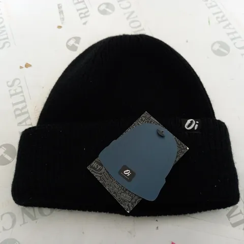 OUTSIDE IN BEANIE HAT IN BLACK