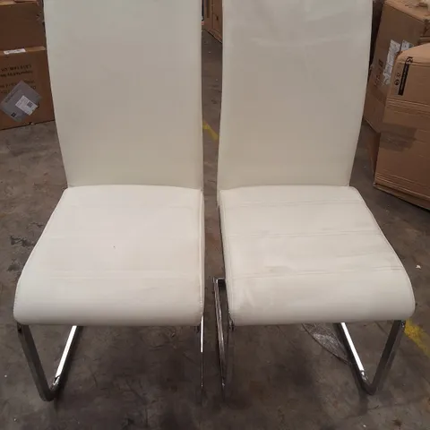 PAIR OF WHITE FAUX LEATHER DINING CHAIRS ON METAL BASES 