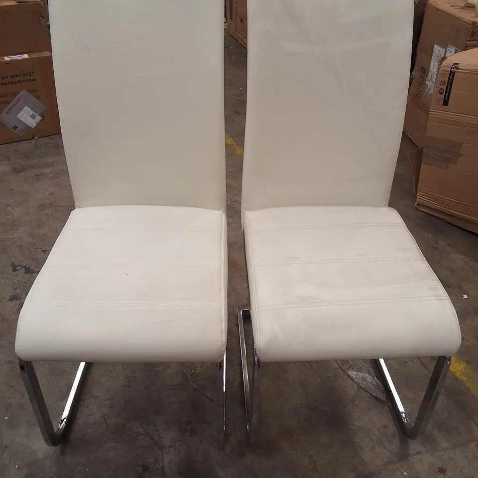 PAIR OF WHITE FAUX LEATHER DINING CHAIRS ON METAL BASES 