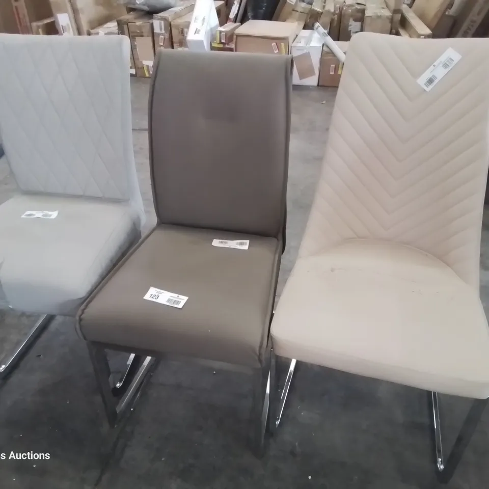 THREE ASSORTED DESIGNER UPHOLSTERED DINING CHAIRS ON METAL FRAMES