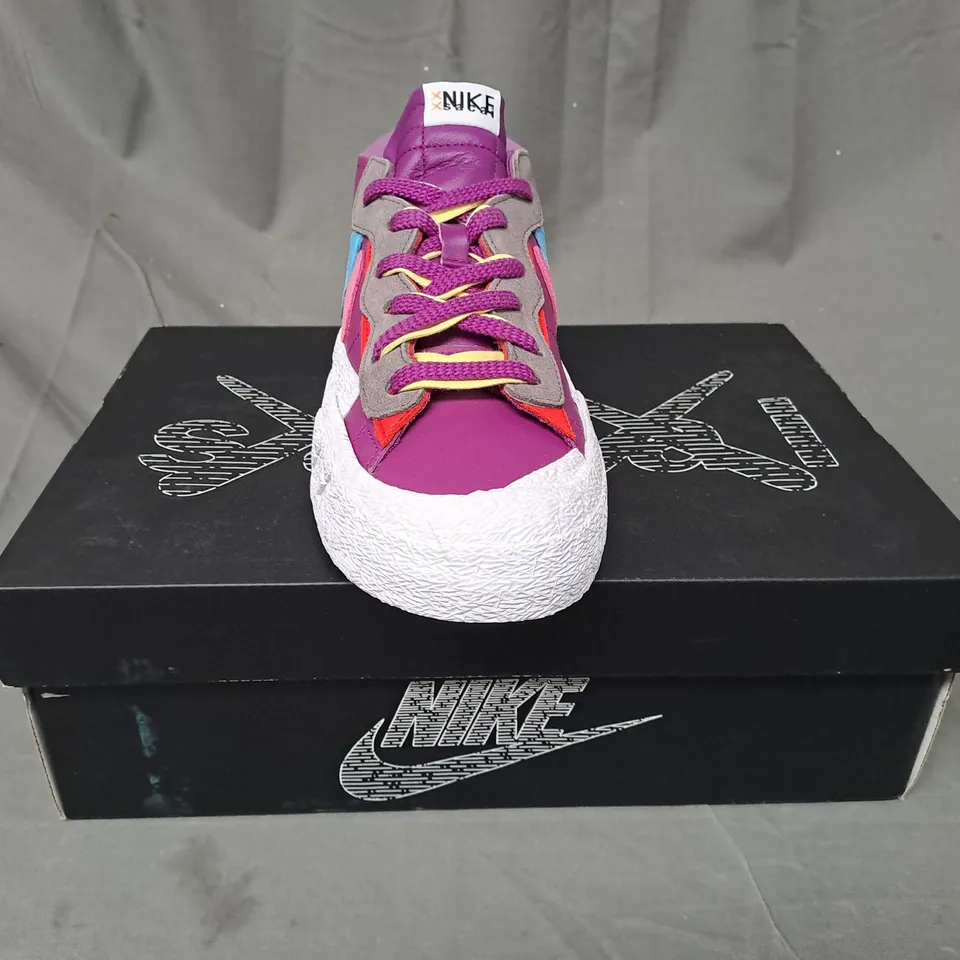 BOXED PAIR OF NIKE BLAZER LOW/SACAI/KAWS SHOES IN PURPLE/BLUE/PINK/WHITE UK SIZE 10