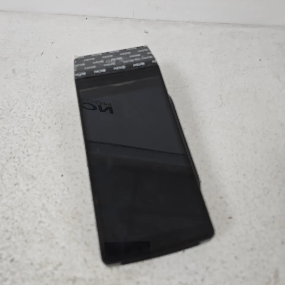 BLACK HANDHELD CARD MACHINE – APPEARS TO BE A DOCKING CRADLE OR ADAPTER