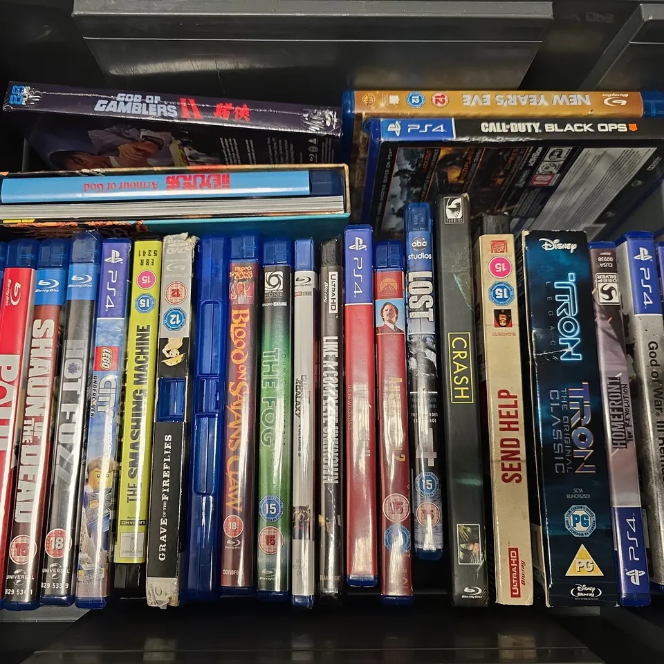 APPROXIMATELY 25 ASSORTED DVDS & GAMES TO INCLUDE HOT FUZZ (BLU-RAY), WOLFENSTEIN II (PS4), GOD OF GAMBLERS II, ETC